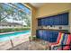 View of screened-in pool with outdoor kitchen and seating at 9757 Hermosillo Dr, New Port Richey, FL 34655