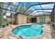 Home pool in screened patio with lounge and mature landscaping at 9757 Hermosillo Dr, New Port Richey, FL 34655
