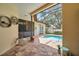 Enclosed lanai features a small in-ground pool, and exterior seating at 9757 Hermosillo Dr, New Port Richey, FL 34655
