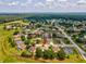 Aerial view of home in a suburban neighborhood with mature trees, a pond, and close proximity to nearby golf course at 2255 Long View Cir, Brooksville, FL 34604