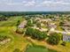 Aerial view of a community with golf course, lake, and lush landscaping showing a tranquil environment at 2255 Long View Cir, Brooksville, FL 34604