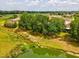 Lush greenery, a pond, and houses in this vibrant aerial view at 2255 Long View Cir, Brooksville, FL 34604