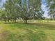 Spacious backyard with large trees overlooking a scenic view of the golf course, offering a serene setting at 2255 Long View Cir, Brooksville, FL 34604