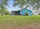 Expansive backyard showcasing a screened patio, lush lawn, and mature trees, perfect for outdoor enjoyment at 2255 Long View Cir, Brooksville, FL 34604