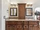 Elegant bathroom featuring a dual sink vanity with granite countertops and decorative lighting fixtures at 2255 Long View Cir, Brooksville, FL 34604