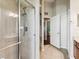 Bright bathroom featuring a glass-enclosed shower and a doorway to an adjacent living space at 2255 Long View Cir, Brooksville, FL 34604