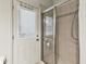 Functional bathroom featuring a glass-enclosed shower and a door leading to the outdoor area at 2255 Long View Cir, Brooksville, FL 34604