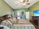 Spacious bedroom with hardwood floors, green walls and a large bed with patterned bedding at 2255 Long View Cir, Brooksville, FL 34604