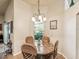 Cozy dining area with a round marble table, four cushioned chairs, and a chandelier at 2255 Long View Cir, Brooksville, FL 34604