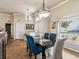 Elegant dining room with blue upholstered chairs, decorative lighting, and large window at 2255 Long View Cir, Brooksville, FL 34604
