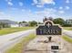 Welcoming entrance sign for Trails neighborhood, featuring a classic design and landscaped surroundings at 2255 Long View Cir, Brooksville, FL 34604
