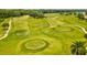 A lush green golf course features well-manicured fairways and greens, surrounded by mature trees and landscaping at 2255 Long View Cir, Brooksville, FL 34604