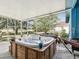 Relaxing screened-in patio featuring a hot tub, perfect for outdoor enjoyment and leisure at 2255 Long View Cir, Brooksville, FL 34604