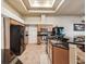 Well-lit kitchen with wooden cabinetry, stainless steel appliances, granite counters, and tile flooring at 2255 Long View Cir, Brooksville, FL 34604