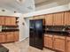 Bright kitchen with wooden cabinets, black appliances, and granite countertops at 2255 Long View Cir, Brooksville, FL 34604