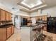 Modern kitchen featuring an island with bar seating, black appliances, and custom cabinetry at 2255 Long View Cir, Brooksville, FL 34604