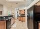 Open kitchen with wooden cabinetry, a breakfast bar, and a view of the dining area at 2255 Long View Cir, Brooksville, FL 34604