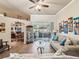 Spacious living room with an adjacent dining area, sliding glass doors, and stylish furnishings at 2255 Long View Cir, Brooksville, FL 34604