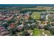 An aerial view of the community showcasing the golf course and water views at 10645 Garda Dr, Trinity, FL 34655