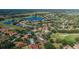 Picturesque aerial view of a community with golf course, lakes, and lush greenery at 10645 Garda Dr, Trinity, FL 34655