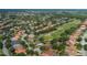 A bird's eye view of a beautiful home that sits beside a lush golf course at 10645 Garda Dr, Trinity, FL 34655