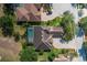 An aerial view of a tile roof home, a screened in pool and beautiful landscaping at 10645 Garda Dr, Trinity, FL 34655