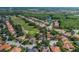 Aerial view of a beautiful community with lush green golf course and tranquil lake at 10645 Garda Dr, Trinity, FL 34655