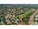 An aerial view of a home next to a beautiful golf course in a lush, green community at 10645 Garda Dr, Trinity, FL 34655