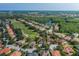 Aerial view of home in a community with a golf course and lake at 10645 Garda Dr, Trinity, FL 34655