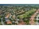 Scenic aerial view of golf community featuring lush trees and a sprawling green golf course at 10645 Garda Dr, Trinity, FL 34655
