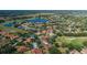 Scenic aerial view of a home nestled in a vibrant neighborhood with a serene lake nearby at 10645 Garda Dr, Trinity, FL 34655