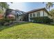Home with a screened-in pool and backyard area overlooking a golf course at 10645 Garda Dr, Trinity, FL 34655
