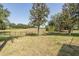 Expansive backyard view featuring a black fence with golf course in the distance at 10645 Garda Dr, Trinity, FL 34655