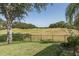 Beautiful backyard of the home with green grass and a view of the golf course at 10645 Garda Dr, Trinity, FL 34655