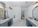 Bright bathroom featuring double sinks, a freestanding tub, and sleek marble flooring at 10645 Garda Dr, Trinity, FL 34655