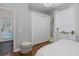 Bedroom with hardwood floors, closet, white dresser, and open view to the pool through glass doors at 10645 Garda Dr, Trinity, FL 34655