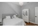Bedroom with plush bed, white dresser, a mirrored wardrobe, and chandelier lighting at 10645 Garda Dr, Trinity, FL 34655