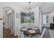 Cozy dining area with round wood table and views of the screened-in lanai and pool area at 10645 Garda Dr, Trinity, FL 34655