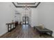 Elegant foyer featuring wood-look tile floors, sophisticated lighting fixtures, and a view through to the dining area at 10645 Garda Dr, Trinity, FL 34655