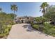 Attractive home featuring lush tropical landscaping, a spacious brick driveway, and a three-car garage in a desirable neighborhood at 10645 Garda Dr, Trinity, FL 34655