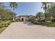 A beautiful home with a paver driveway, mature landscaping, and a well-manicured lawn at 10645 Garda Dr, Trinity, FL 34655