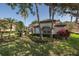 Lush front yard of home showcasing landscaping, shrubbery and mature palm trees at 10645 Garda Dr, Trinity, FL 34655