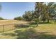 Backyard view of the golf course, enclosed by the black, metal fence at 10645 Garda Dr, Trinity, FL 34655