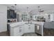 Open kitchen featuring island seating, stainless steel appliances, and seamless flow into the living room at 10645 Garda Dr, Trinity, FL 34655