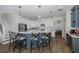 Well-equipped kitchen with island seating, stainless appliances, white cabinets, and herringbone backsplash at 10645 Garda Dr, Trinity, FL 34655