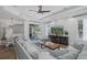Spacious living room adjacent to dining area, featuring modern sectional and access to the outdoor patio at 10645 Garda Dr, Trinity, FL 34655