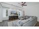 Cozy living room with a decorative shiplap wall, a TV and a sectional sofa at 10645 Garda Dr, Trinity, FL 34655