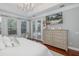 Main bedroom includes a large dresser and a wall-mounted television; views of the pool area at 10645 Garda Dr, Trinity, FL 34655