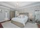 Relaxing main bedroom with a plush rug, wood flooring, and view of the en suite bathroom at 10645 Garda Dr, Trinity, FL 34655