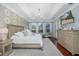 Bright and airy main bedroom boasts stylish furnishings and an abundance of natural light at 10645 Garda Dr, Trinity, FL 34655
